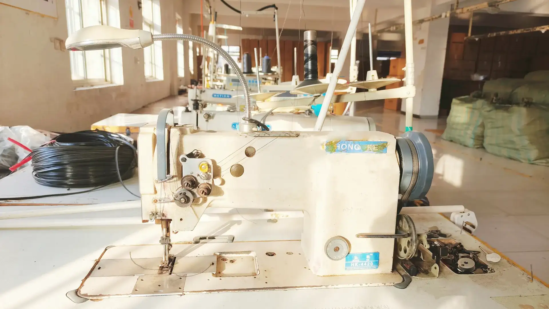 Live video walkthrough of a bag factory sewing floor during a remote supplier audit.