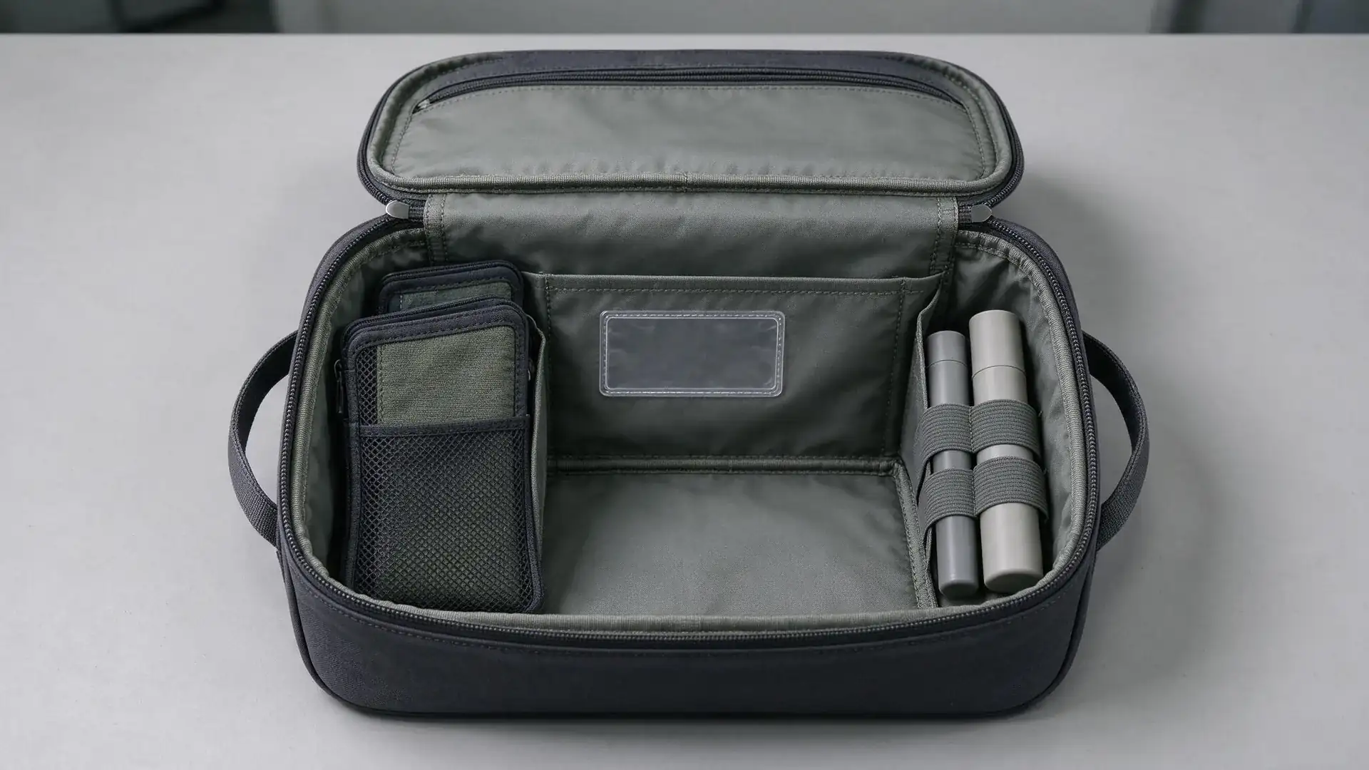 Open medical organizer bag compartment layout showing removable pouches, elastic loops, clear label window, and quick-access outer pocket on a neutral worktable for healthcare workflow planning.
